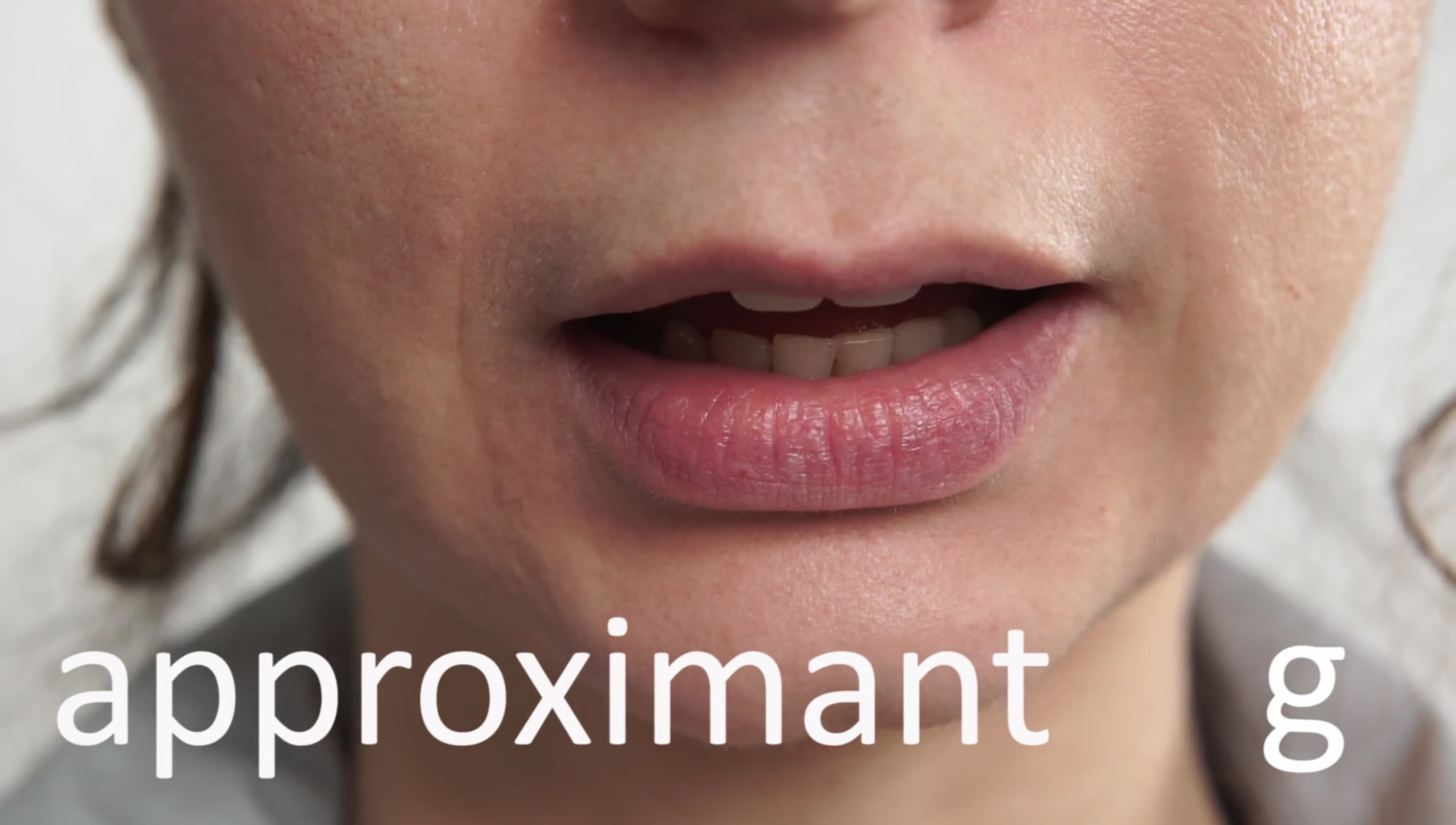 The image shows a close up of someone's open mouth with the word "approximant  g" written across the bottom in white. 